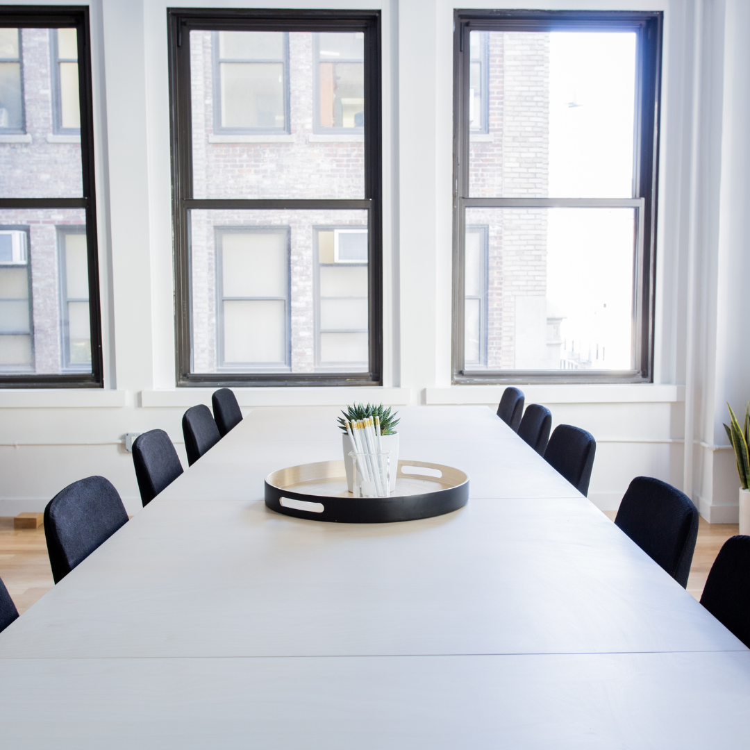 A conference room with openable windows lining the walls